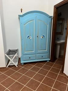 a blue cabinet in a bathroom with a sink at Domo Rosada in Ottava Sassari +19 photos