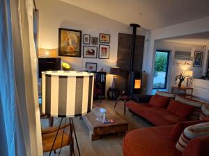 a living room with a couch and a table at Tycoat in Carantec +27 photos
