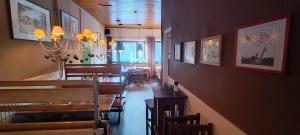 a dining room with wooden tables and chairs in a restaurant at Wróbelek in Wetlina +26 photos