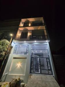 a white building with a black door at night at Arctic Inn in Gorakhpur