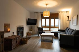 a living room with a couch and a table at Casa Prada en Sanabria in Puebla de Sanabria