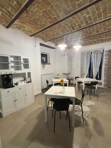 a kitchen and dining room with white tables and chairs at Lo Shangrilá B&B in Borrello