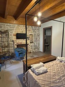 a bedroom with a bed and a stone fireplace at Lo Shangrilá B&B in Borrello