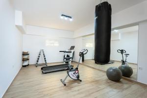a gym with weights and exercise equipment in a room at Sirens Resort in Agioi Apostoli