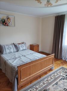 a bedroom with a bed with a blue comforter at Ольга in Ogrody