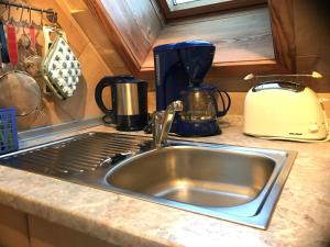a kitchen counter with a sink and a toaster at Ferienwohnung Dorle in Benneckenstein +18 photos