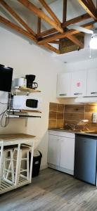 a kitchen with white cabinets and a counter top at L'Escale Balnéaire Landaise in Biscarrosse-Plage
