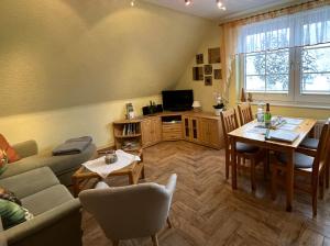 a living room with a table and a dining room at Ferienwohnung Dorle in Benneckenstein
