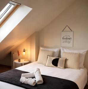 a bedroom with a large white bed in a attic at Le cocon San Francisco in Tours