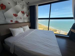 a bedroom with a bed with a view of the ocean at Apec Mandala Chambay - Dimond Hotel in Ấp Thiẹn Ái +37 photos