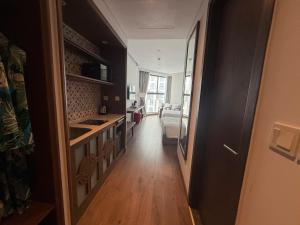 a hallway with a kitchen and a living room at Apec Mandala Chambay - Dimond Hotel in Ấp Thiẹn Ái