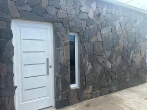 a stone wall with a door and a window at Deptos Helen in Termas de Río Hondo