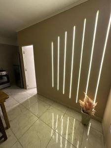 a room with a wall with vertical blinds on it at Deptos Helen in Termas de Río Hondo