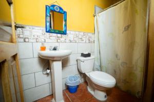 a bathroom with a toilet and a sink and a mirror at El Mirador de Lanquin in Lanquín +58 photos