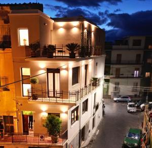 a building with potted plants on the balconies at night at SVR Green in Bronte