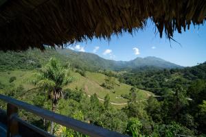 a view of the mountains from a thatch hut at El Mirador de Lanquin in Lanquín