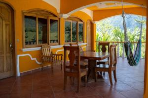 a dining room with a table and chairs at El Mirador de Lanquin in Lanquín