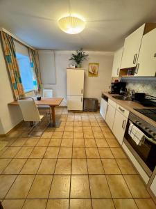 a kitchen with a table and a refrigerator and a table at Haus Anna in Köttwein