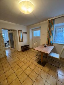 a living room with a wooden table and chairs at Haus Anna in Köttwein