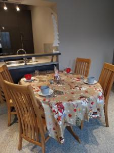 a dining room table with a christmas table cloth on it at Gîte d'ammerschwihr in Ammerschwihr