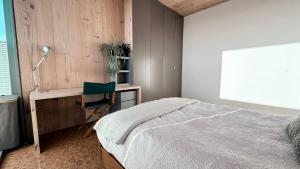 a bedroom with a bed and a desk and a chair at Flat 4A in Edinburgh