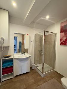 a bathroom with a shower and a sink and a toilet at Apartament Loft DeLuxe Koszalin in Koszalin +11 photos