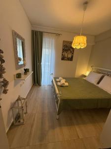 a bedroom with a green bed and a window at The litlle mermaid in Amaliapoli