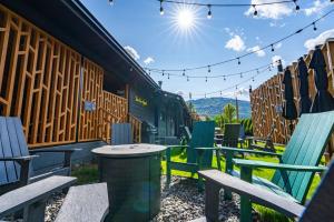 a group of chairs and a table in front of a building at Gravity Haus Revelstoke in Revelstoke