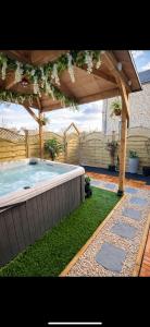 a swimming pool under a wooden pergola at Yorkshire Barn Escape 2 bedroom in Keighley