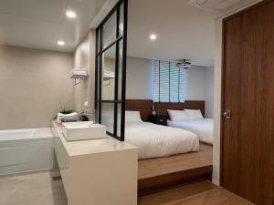 a bedroom with a bed and a sink and a tub at 무무 mumu in Seoul