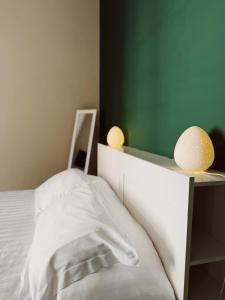 a bedroom with a bed with two lights on it at Diaz Central Rooms in Salerno