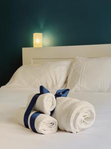 a pile of towels sitting on top of a bed at Diaz Central Rooms in Salerno