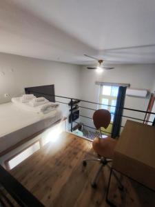a bedroom with a bed and a chair and a table at Apartment Studio 7 in Mytilene