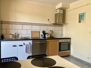 a kitchen with a table and a counter top at Appartement T3 avec grand balcon in Le Pradet