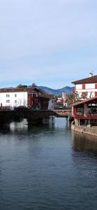 a bridge over a river with buildings on it at Compostelle Chemin Garazi in Uhart-Cize