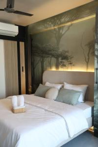 a bedroom with a large white bed with a painting on the wall at Chérie Bliss Loft in Jaipur
