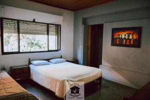 a bedroom with two beds and a window at HOSTEL DEL HERRERO in Apóstoles