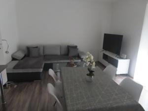 a living room with a couch and a table at Apartment Vlora-Naturblick in Villach