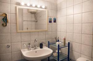 un bagno con lavandino e specchio di Casa Elena Spetses a Spetses