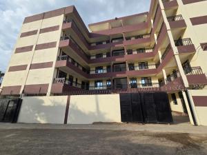 an apartment building with a fence in front of it at Waridi Homes One-bedroom Naivegas Apartment in Naivasha