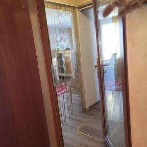 a door leading into a room with a glass doorway at House with a fireplace in Daugavpils