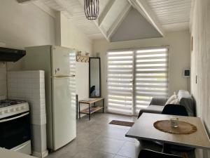 a kitchen with a refrigerator and a table in a room at Sur Alojamiento Ushuaia in Ushuaia