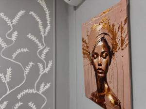 a painting of a woman on a wall at Cilipo House in Palomino