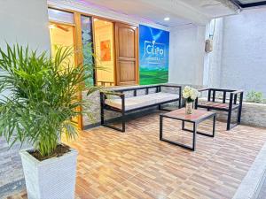 two benches and a table in front of a store at Cilipo House in Palomino