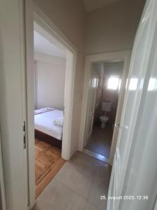 a small bedroom with a bed and a bathroom at Topla in Herceg-Novi