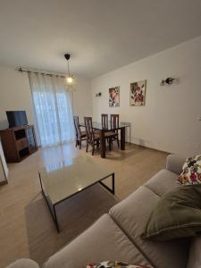 a living room with a couch and a table and chairs at Apartamento Escobar Plaza in Nerja