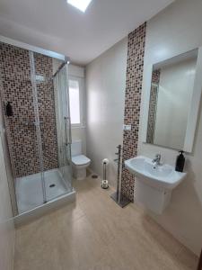 a bathroom with a shower and a sink and a toilet at Apartamento Escobar Plaza in Nerja +25 photos