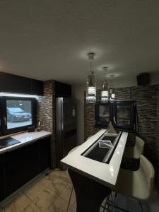 a kitchen with a white counter and a black refrigerator at RestOnTheLake in Esztergom
