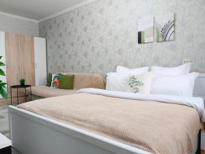 a bedroom with a large bed with white pillows at River Side in Aktobe +13 photos