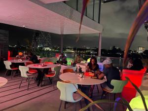a group of people sitting at tables on a roof at Terraform Hotel in Lagos